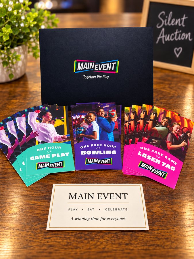 Main Event gift card set for game play, bowling and laser tag, displayed with a Silent Auction sign