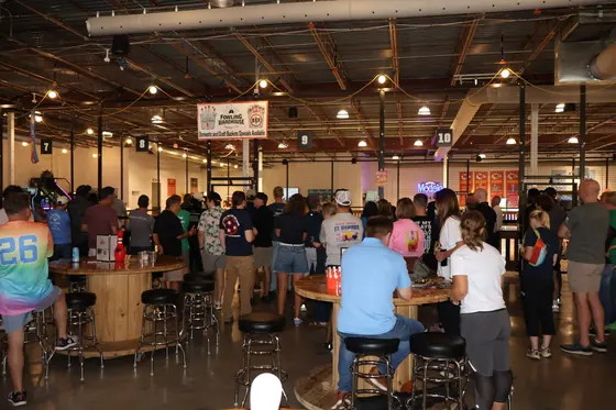 A crowd gathered at the tables inside Fowling Warehouse KC