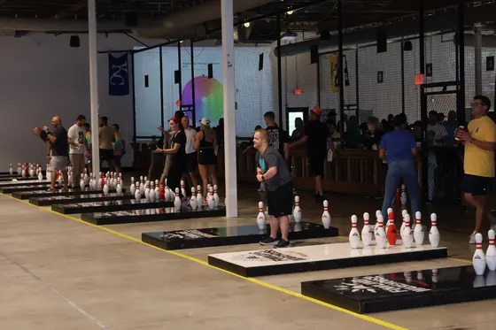 Rows of fowling lanes with players and spectators lining the floor