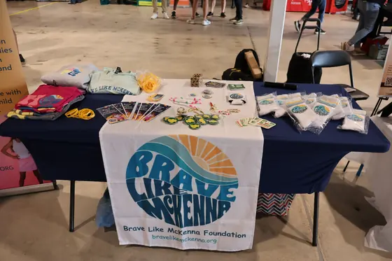 The Brave Like McKenna table covered in merchandise
