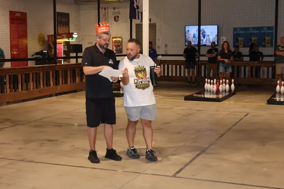 Two players reviewing a score sheet at the lanes