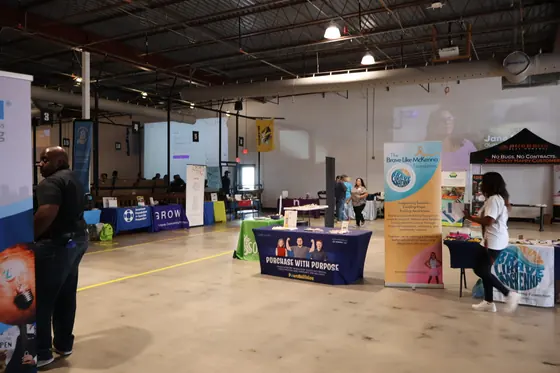 A wide view of nonprofit tables along the wall