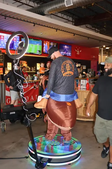A guest in an inflatable costume on the photo booth platform