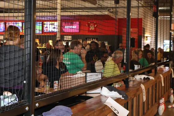Spectators seated behind the netting