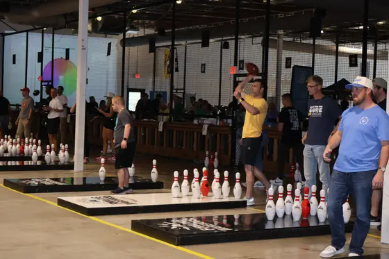 Players waiting at the lanes with pins set