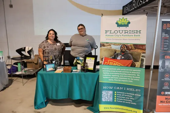 Two volunteers at the Flourish furniture bank table