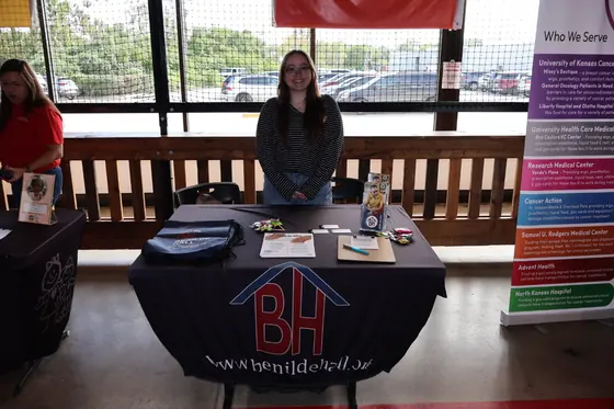 A volunteer behind the Benilde Hall table