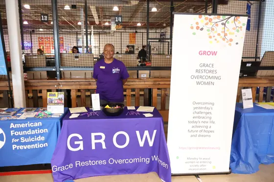 A volunteer in purple at the GROW table