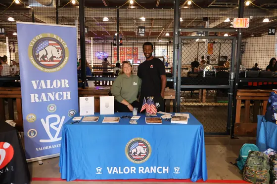 Two people at the Valor Ranch table