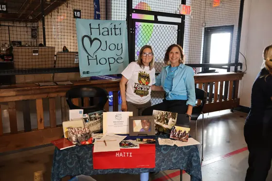 Two women at the Haiti Joy Hope table